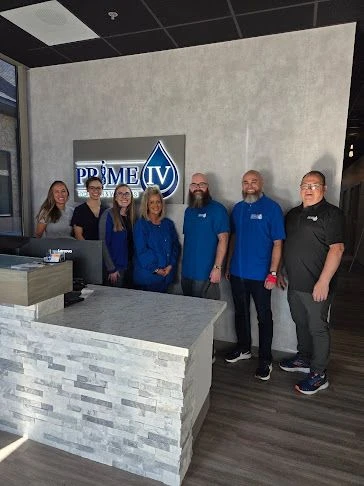 The Prime IV Kansas City team standing together at the Burlington Creek front desk
